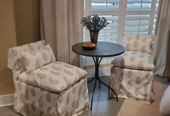 a room with chairs and teapoy